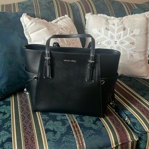 Michael Kor’s Black Voyager Pebbled Leather Tote Bag. More in comments